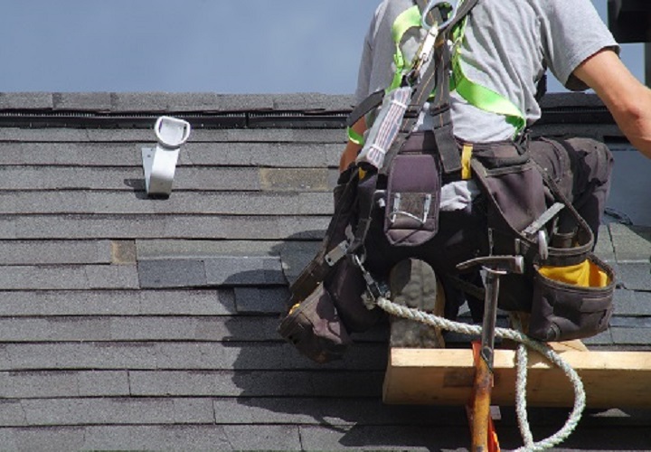 Denver roof repair construction worker roofer man roofing security rope
