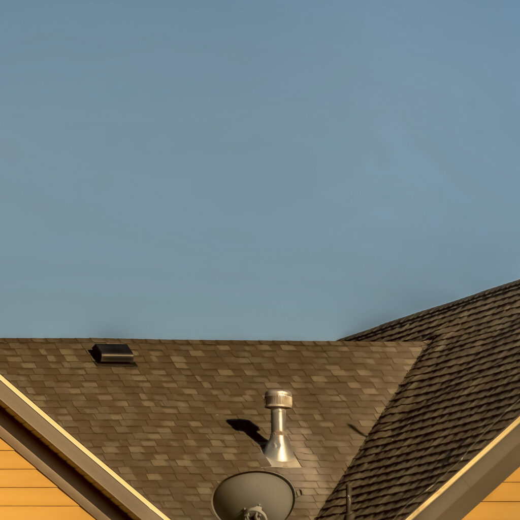 Square House exterior with roof shingles that need Denver roof repair services. 