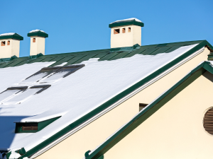 Well-maintained Denver roofing covered with snow in winter.