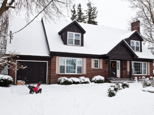 A snowy house with a cool roof installed by Thornton roofing contractors