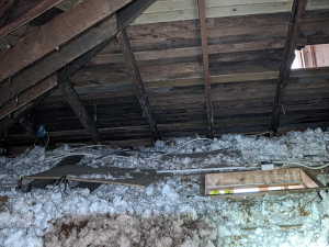 Inspecting roof insulation after storm damage in Castle Pines