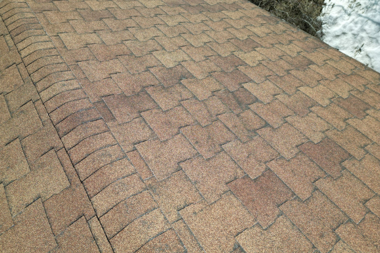 Inspecting a Castle Pines roof for storm damage