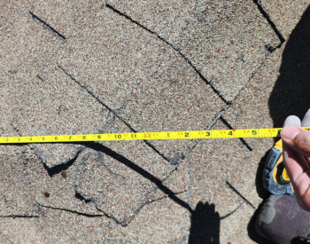 Inspecting roof for storm damage in Thornton