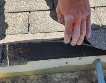 Checking shingles and flashing for damage