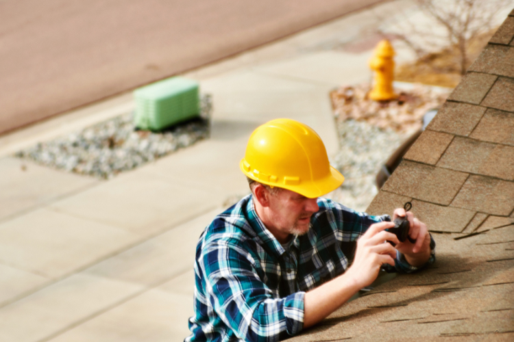 Inspecting hail damage on a Westminster roof
